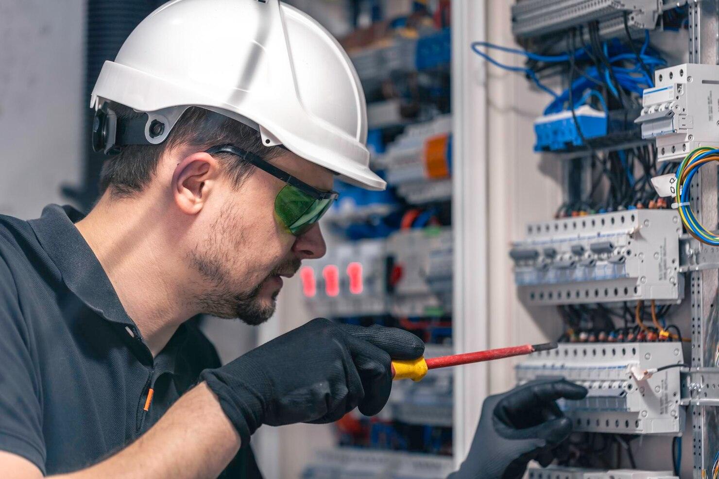 male electrician works switchboard using electrical connection cable 169016 53617