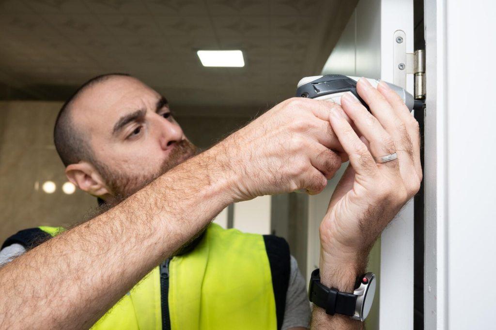 young man fixing door with screwdriver 123827 36994